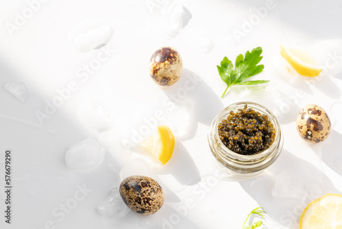 Obraz na płótnie Appetizers of natural sturgeon black caviar, lemon and parsley w salonie