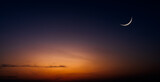 Crescent moon on dusk sky twilight after sundown, well free space for text Arabic religious of Islamic Ramadan Kareem, Eid al Fitr, Eid al Adha, Eid Mubarak 