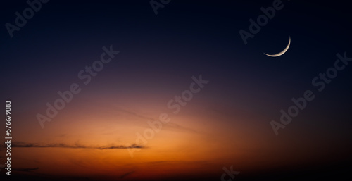Crescent moon on dusk sky twilight after sundown, well free space for text Arabic religious of Islamic Ramadan Kareem, Eid al Fitr, Eid al Adha, Eid Mubarak 
