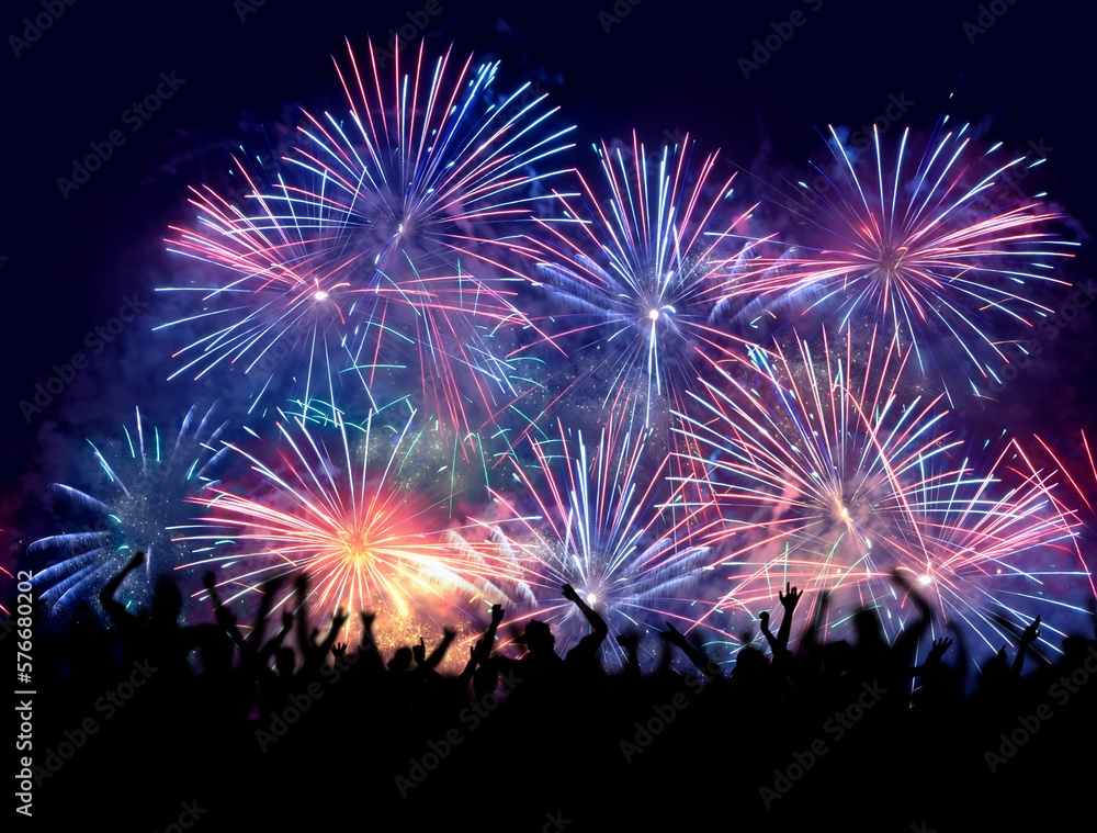 Happy New Year. Crowd watching fireworks and celebrating. Beautiful blue and pink fireworks display lights up the sky with dazzling display during New Year celebration. Greeting card, flyer template