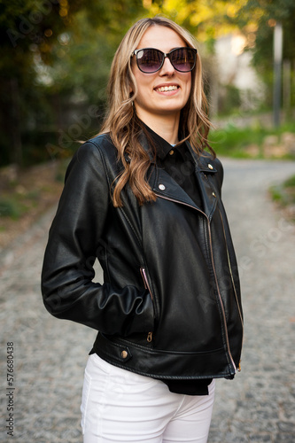 woman in black leather jacket wearing black sunglasses