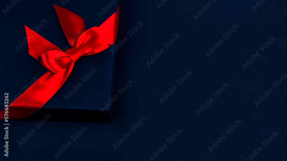 blue gift box with a red bow on blue background.