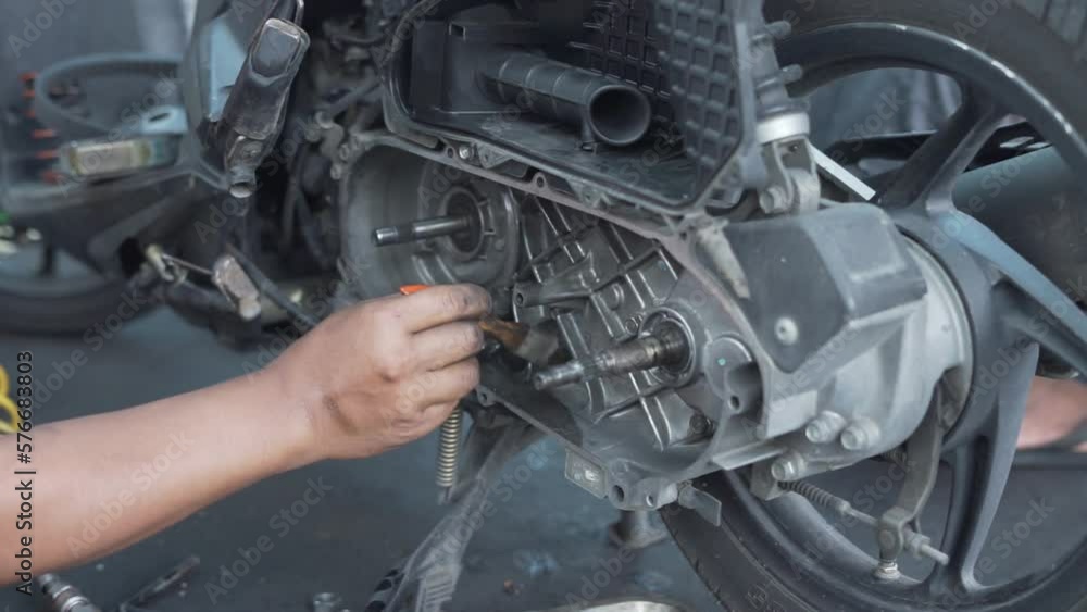 Hands of a mechanic cleaning automatic motorcycle spare parts Hands of a mechanic cleaning automatic motorcycle spare parts