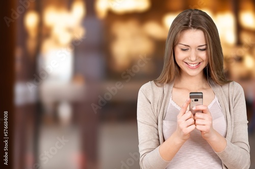 Young busy happy woman hold mobile phone