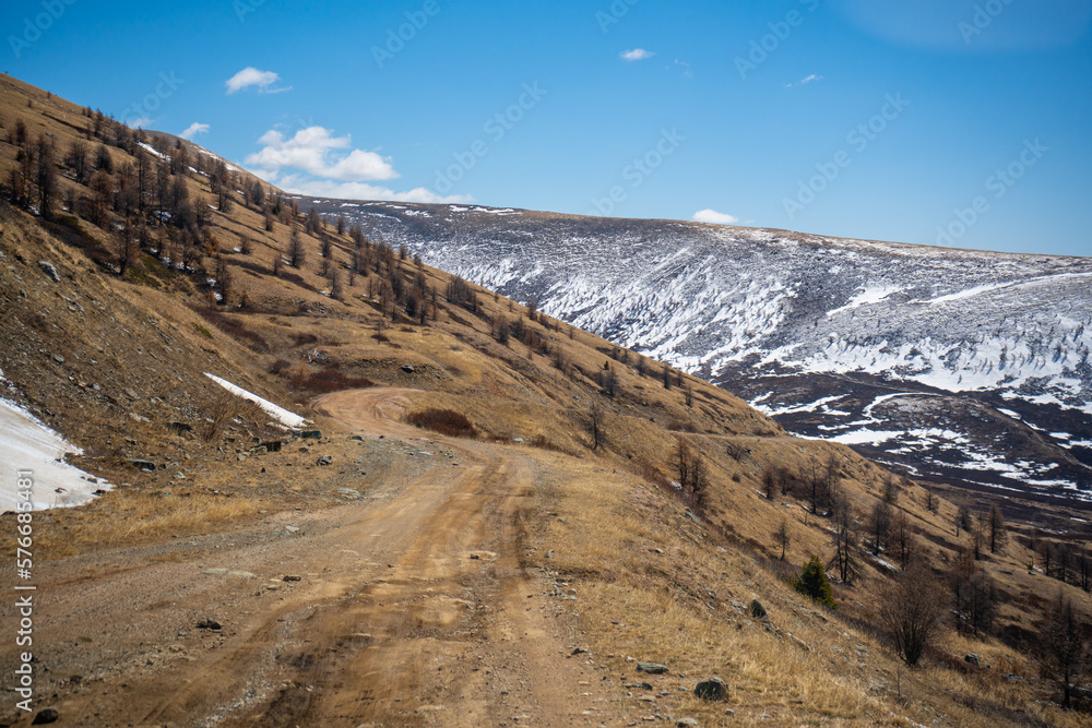 Road from a repeater on snowy tops of Altai mountains near Aktash town, Russia