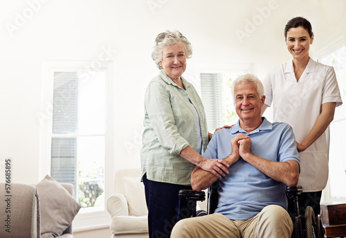 Portrait of old man in wheelchair, elderly couple with nurse and smile at nursing home for care and rehabilitation. Healthcare, disability and happy senior with caregiver and woman in living room.