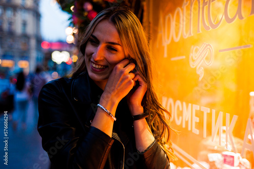 Woman wearing casual clothes walking in warm autumn evening city