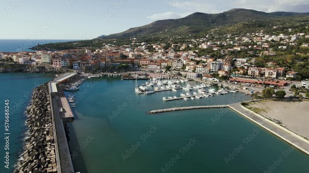 Aerial view of Marina di Camerota, a small town with the harbour along the Mediterranean coastline, Salerno, Italy. Aerial view of Marina di Camerota, a small town with the harbour along the Mediterranean coastline, Salerno, Italy.