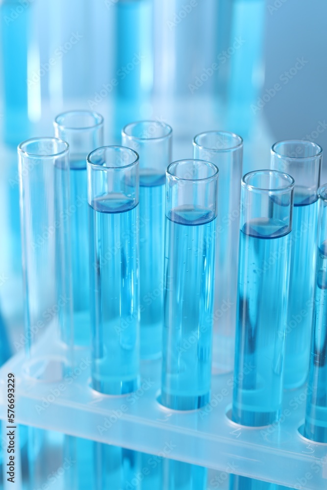 Test tubes with light blue liquid in laboratory, closeup Test tubes with light blue liquid in laboratory, closeup