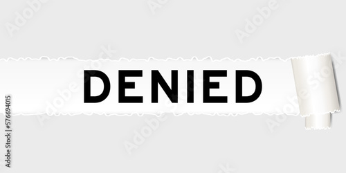 Ripped gray paper background that have word denied under torn part