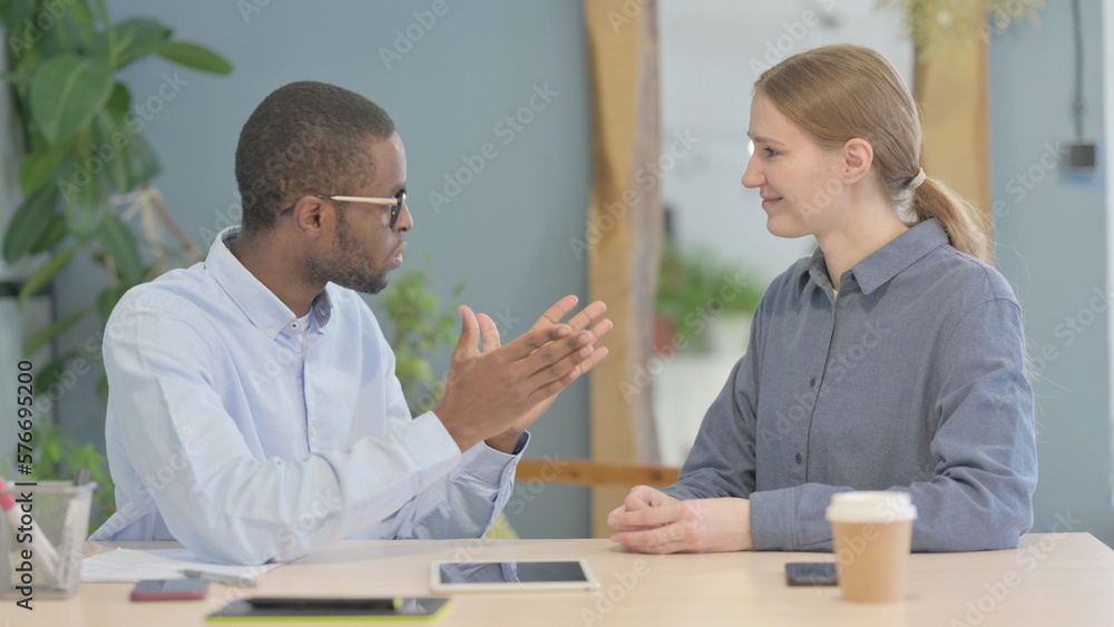 Young African Businessman Discussing Work with Partner Young African Businessman Discussing Work with Partner