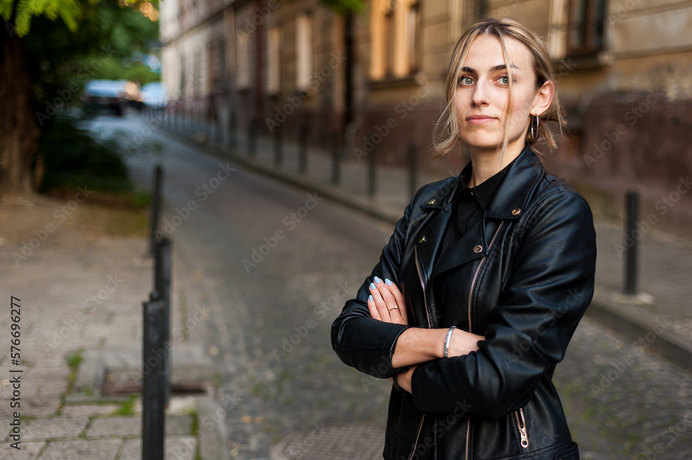 Woman wearing casual clothes walking in warm autumn evening city