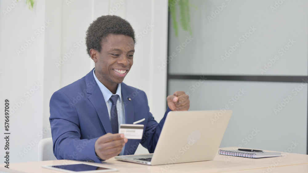 African Businessman making Successful Online Payment on Laptop African Businessman making Successful Online Payment on Laptop