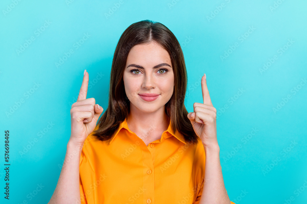 Portrait of good mood satisfied pretty girl with bob hair dressed yellow shirt directing empty space isolated on blue color background Portrait of good mood satisfied pretty girl with bob hair dressed yellow shirt directing empty space isolated on blue color background