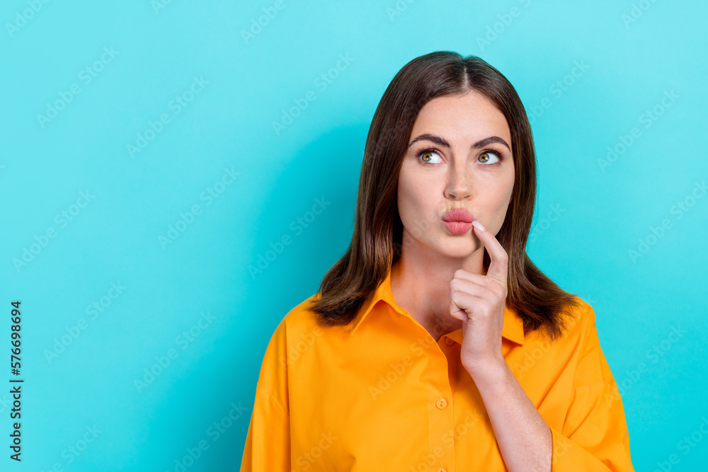 Portrait of good mood optimistic girl bob hairstyle dressed yellow shirt look empty space hand mouth isolated on blue color background Portrait of good mood optimistic girl bob hairstyle dressed yellow shirt look empty space hand mouth isolated on blue color background