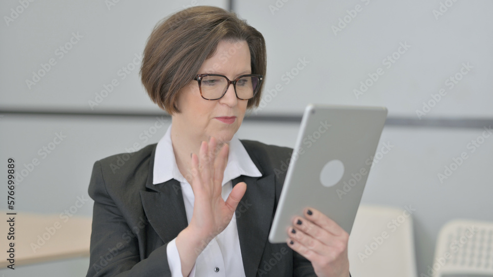 Old Businesswoman Doing Online Video Chat on Tablet Old Businesswoman Doing Online Video Chat on Tablet
