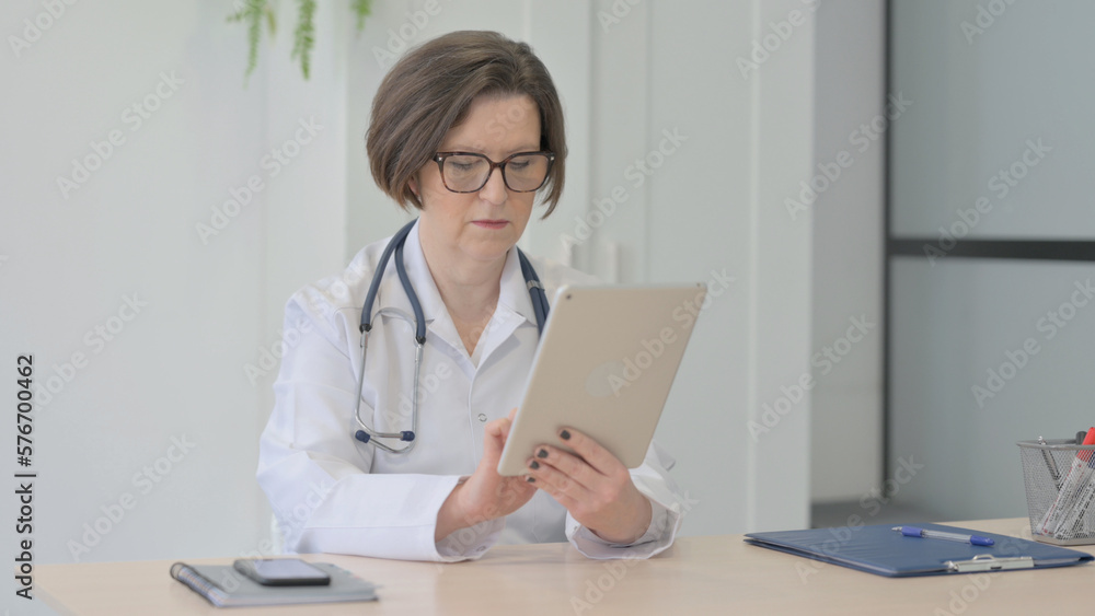 Old Female Doctor Browsing Tablet in Clinic Old Female Doctor Browsing Tablet in Clinic