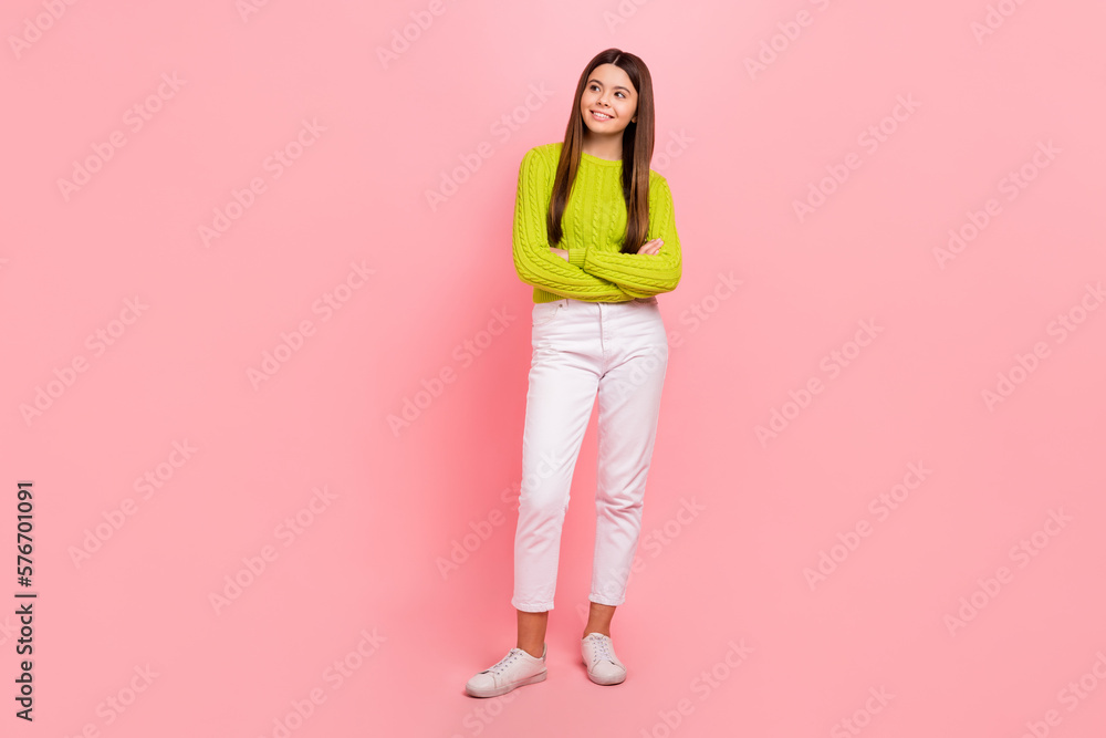 Full size photo of lovely teen lady crossed arms look empty space shopping wear trendy green garment isolated on pink color background Full size photo of lovely teen lady crossed arms look empty space shopping wear trendy green garment isolated on pink color background