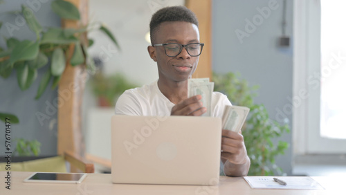 Happy African Man Counting Dollar in Office