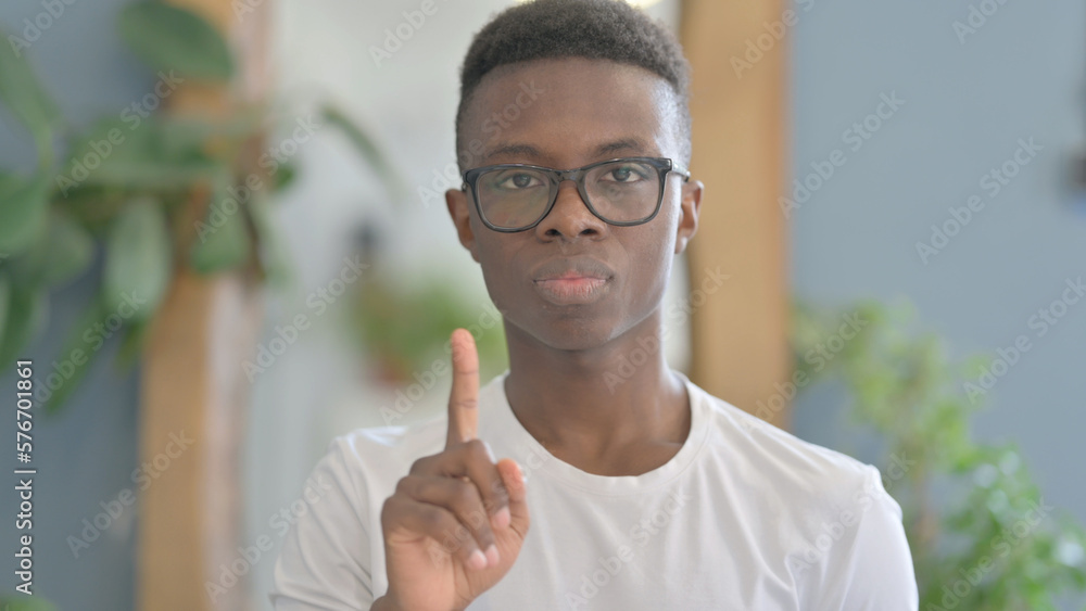 Fototapeta premium Portrait of Disliking Young African Man Shaking Head in Rejection