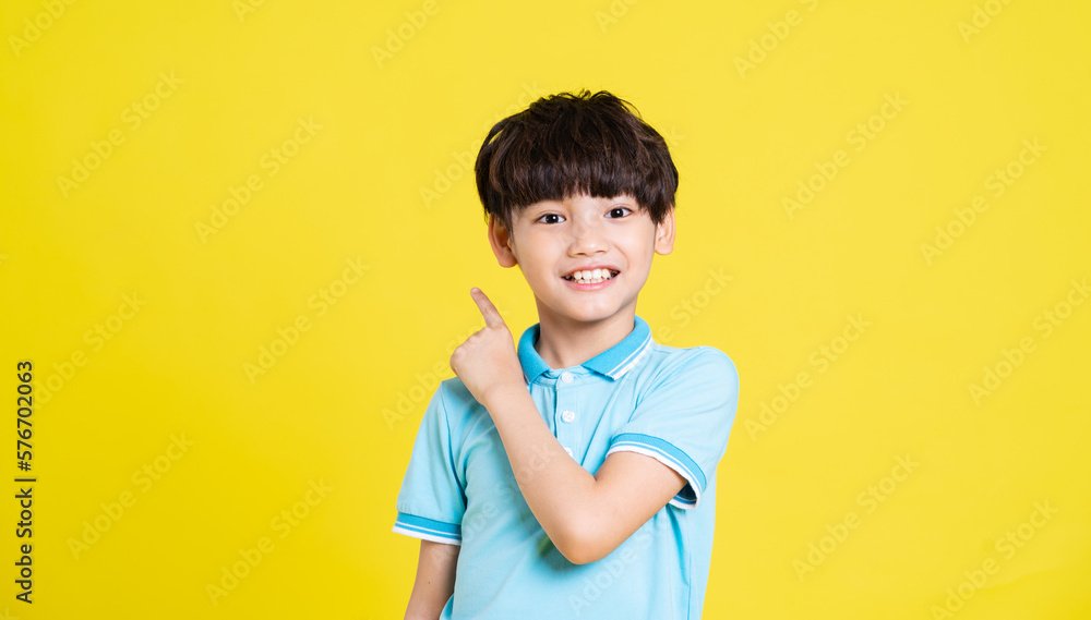 portrait of an asian boy posing on a yellow background portrait of an asian boy posing on a yellow background