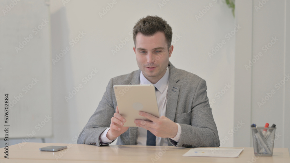 Online Video Chat on Tablet by Young Businessman Online Video Chat on Tablet by Young Businessman