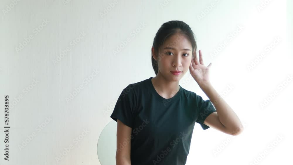Asian woman eavesdropping ,Overhearing secret conversation isolated on yellow background, Gossip, Listening, White background studio portrait. Asian woman eavesdropping ,Overhearing secret conversation isolated on yellow background, Gossip, Listening, White background studio portrait.
