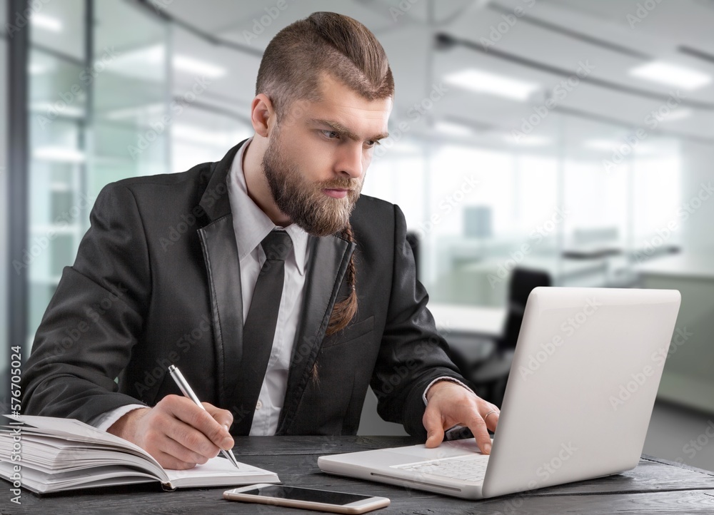 Busy businessman working in office on computer Busy businessman working in office on computer