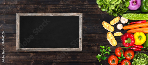 vegetables on wooden table with a  blackboard