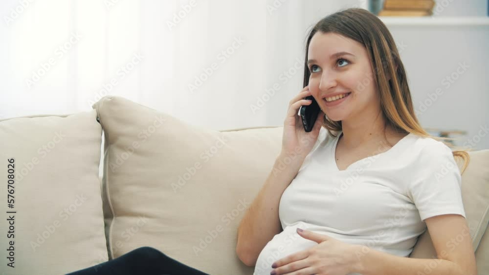 4k slowmotion video of smiling pregnant woman talking over the phone. 4k slowmotion video of smiling pregnant woman talking over the phone.