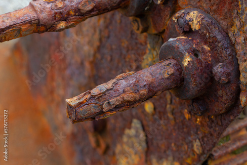 Detail of severe marine metal corrosion on an old boat crank by the sea, selective focus.