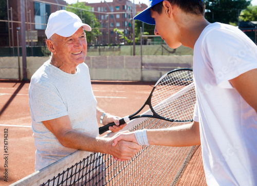 tennis players of different generations shake hands before tennis match © caftor
