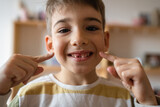 boy with Deciduous primary milk teeth lost tooth fallen out dropped