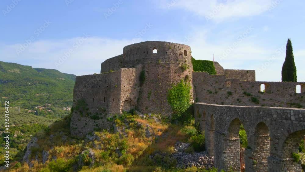 This aerial stock video captures the stunning ruins of the Old Bar or Stari Bar, a historical landmark in Montenegro. The drone footage showcases a bird's eye view of a stone fortress and an aqueduct This aerial stock video captures the stunning ruins of the Old Bar or Stari Bar, a historical landmark in Montenegro. The drone footage showcases a bird's eye view of a stone fortress and an aqueduct