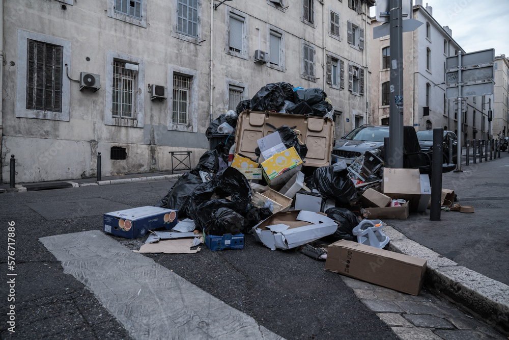 garbage heaps and bins in a city street of Paris in France