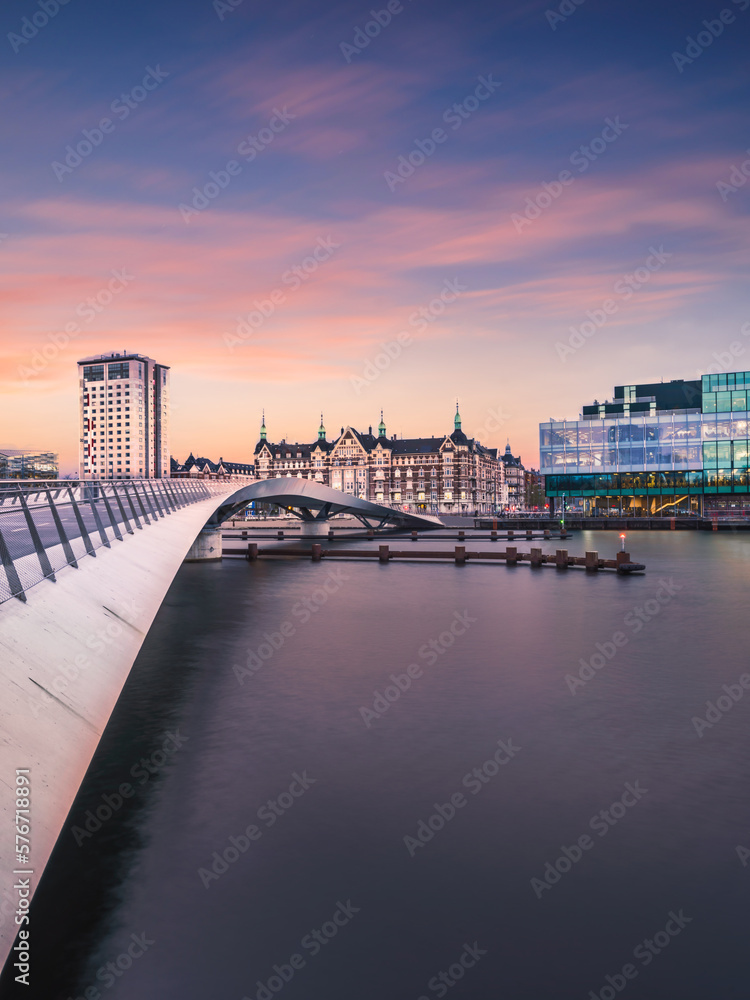 Lille Langebro cycle and pedestrian bridge and city buildings after sunset in Copenhagen, Denmark
