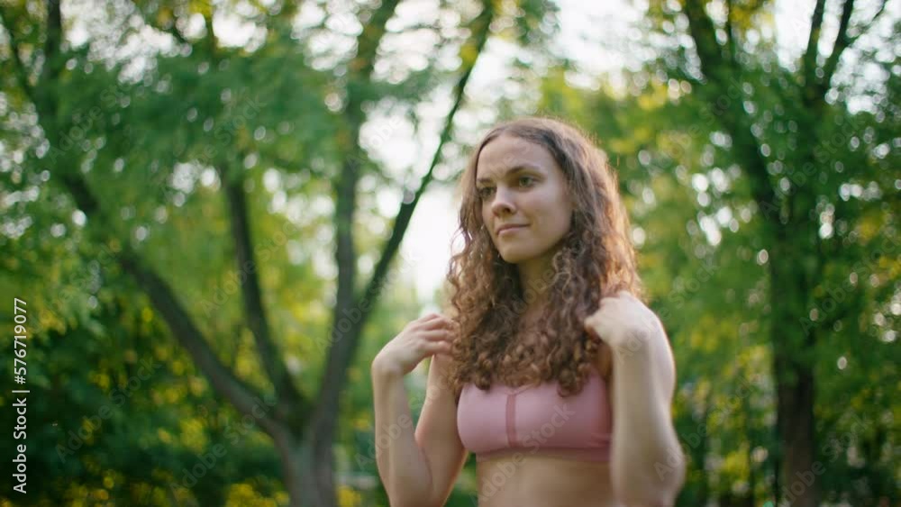 Young Woman doing Mobility Workout in Park. Fit Lady rotating shoulders outside surrounded by Trees. Keeping fit, stretching and Healthy Lifestyle concept. 4K mid orbit shot Young Woman doing Mobility Workout in Park. Fit Lady rotating shoulders outside surrounded by Trees. Keeping fit, stretching and Healthy Lifestyle concept. 4K mid orbit shot