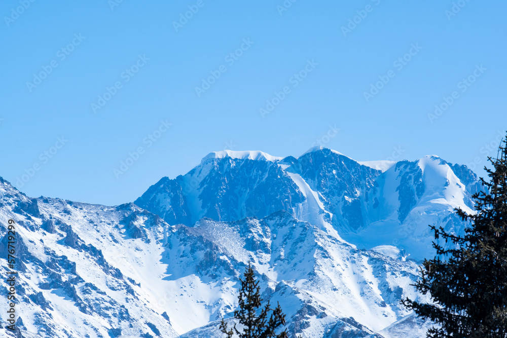 Panorama of Talgar Peak near Almaty. View of Talgar Peak from the forest pass in winter.