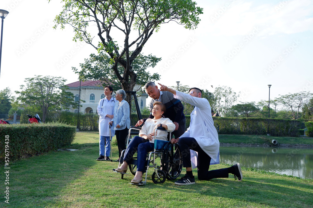 Male doctor caring for an elderly patient in a wheelchair concept of caring for the elderly.
