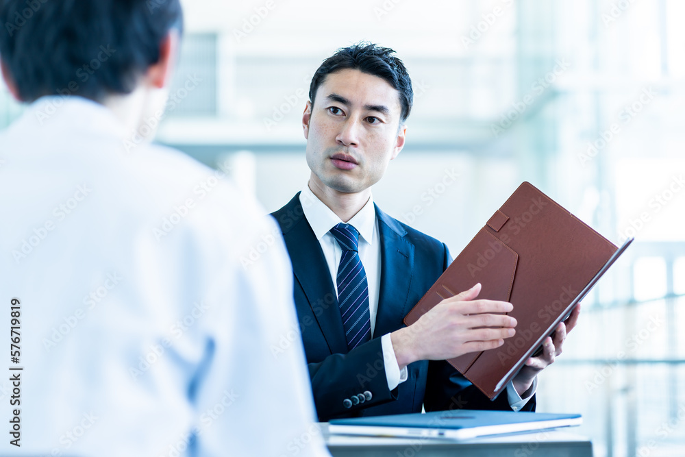 白衣を着た男性とスーツを着たビジネスマン 白衣を着た男性とスーツを着たビジネスマン