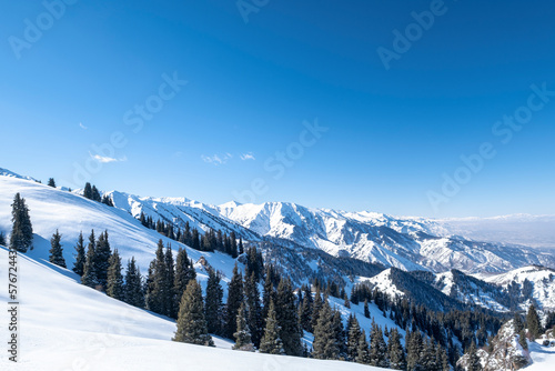 Winter landscape in the mountains, spruces and mountain peaks.