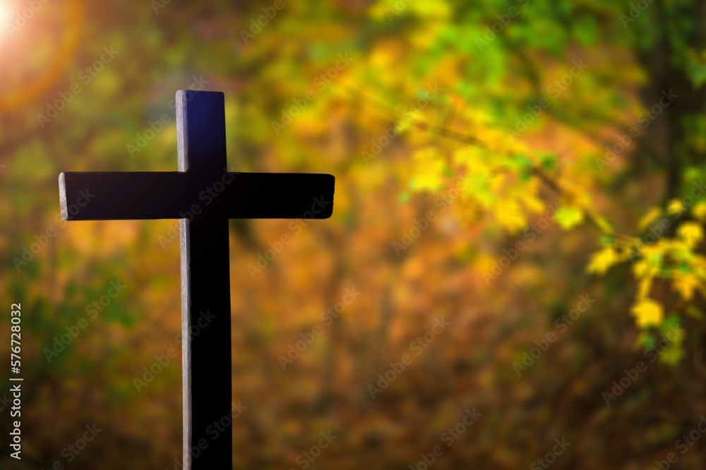 Holy wooden cross on nature background