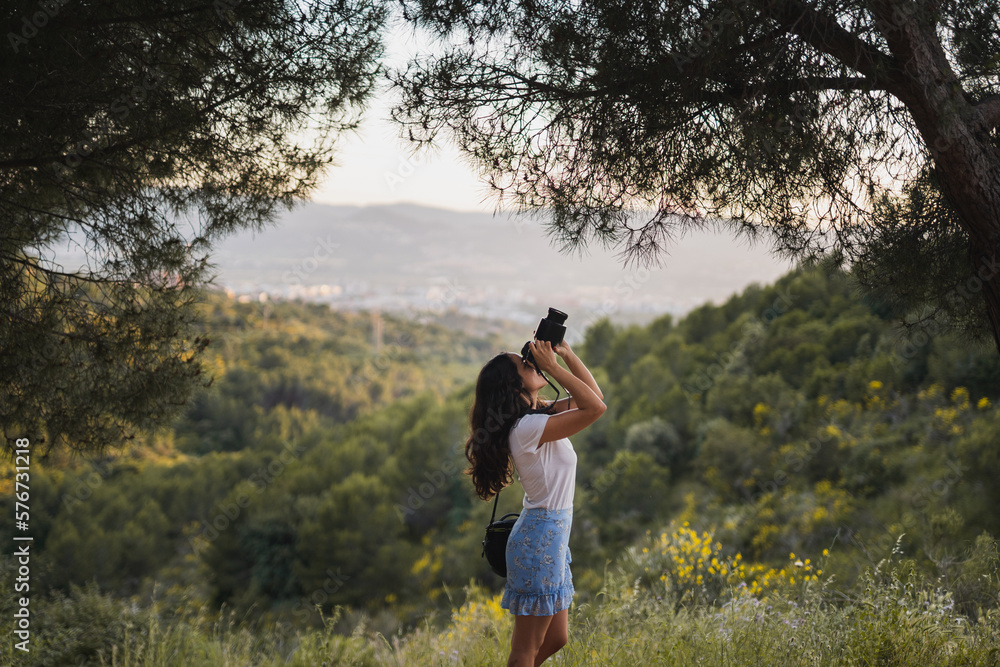 Traveling woman taking photo of nature Traveling woman taking photo of nature