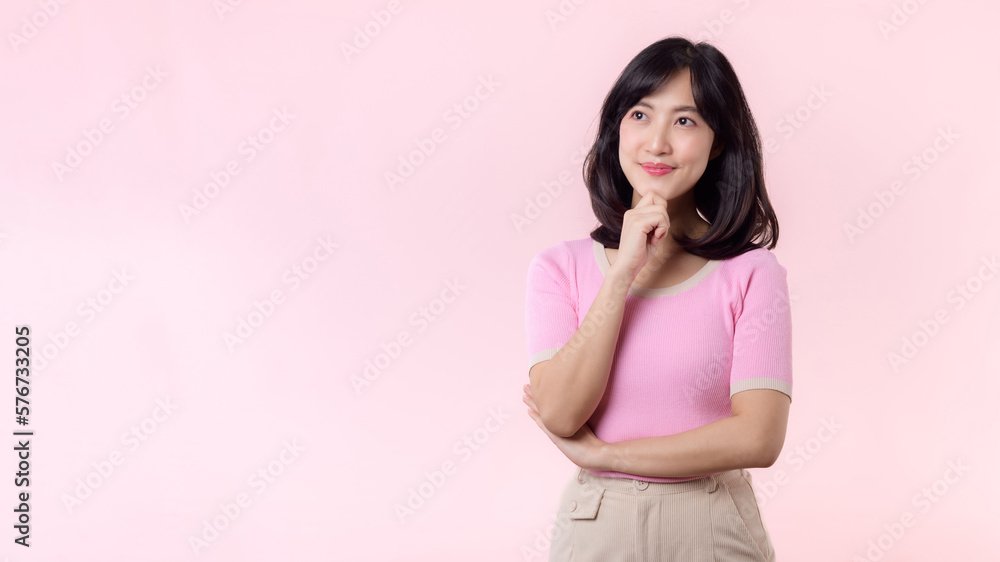 Portrait beautiful young asian woman thoughtful thinking an idea isolated on pink pastel background. Teenage female person pretty smile with thinking gesture concept. Portrait beautiful young asian woman thoughtful thinking an idea isolated on pink pastel background. Teenage female person pretty smile with thinking gesture concept.