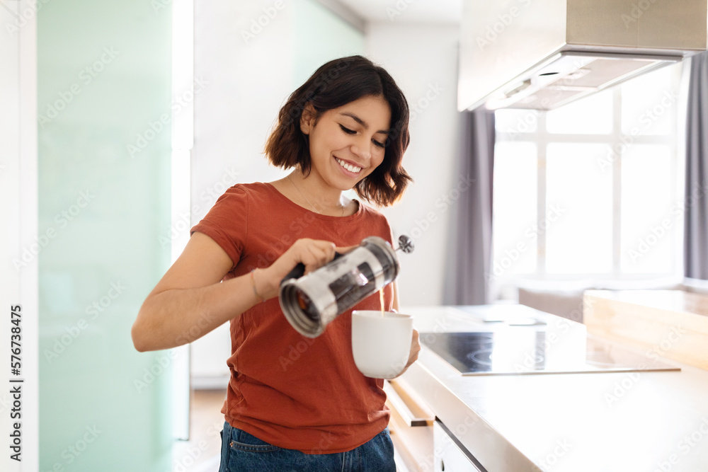 Portrait Of Young Smiling Arab Woman Making Morning Coffee At Home Portrait Of Young Smiling Arab Woman Making Morning Coffee At Home