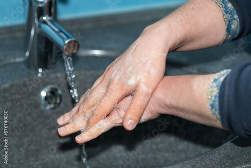 Total hand washing   woman washing her hands to avoid diseases like coronavirus