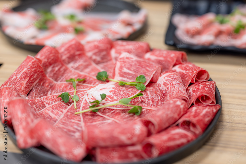 Slice of fresh raw beef at hot pot restaurant