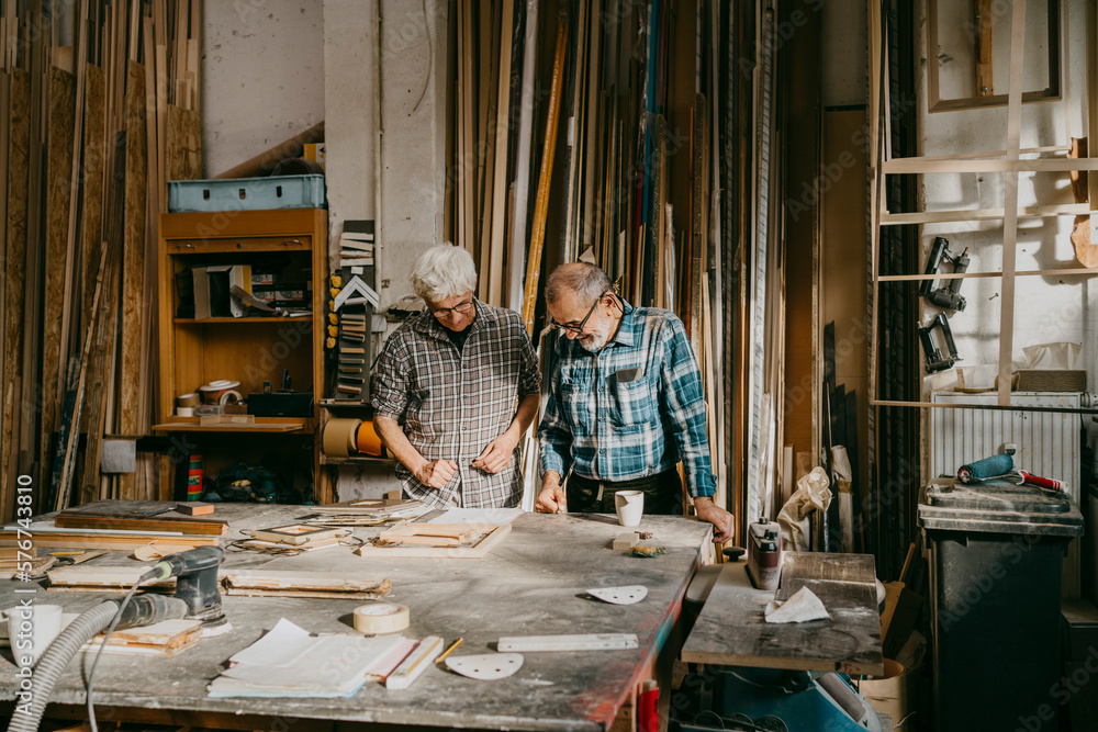 Senior craftsmen working together at carpentry workshop Senior craftsmen working together at carpentry workshop
