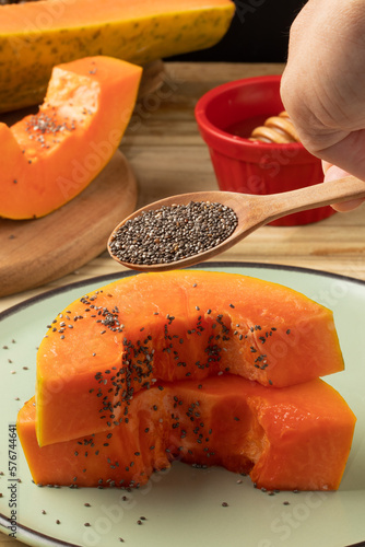 Focus on chia seeds on pieces of papaya.