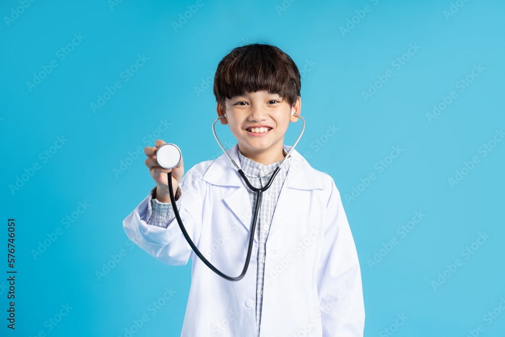 Asian boy portrait posing on blue background Asian boy portrait posing on blue background